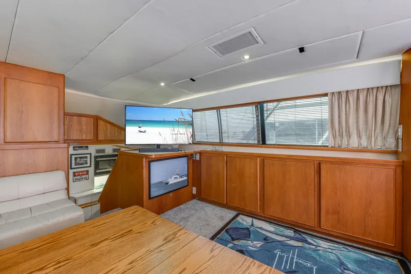 Slide: The Image of Interior of 1990 Bertram 50 Convertible yacht with wood paneling and modern amenities. - 17