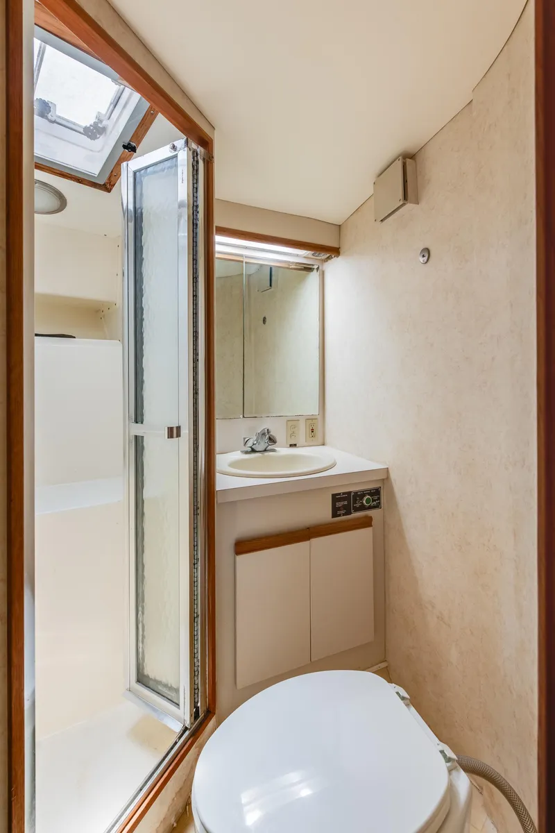 Slide: The Image of 1990 Bertram 50 Convertible yacht bathroom with shower and skylight. - 25
