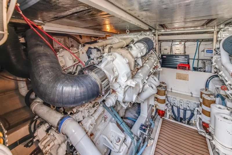 Slide: The Image of Engine room of a 1990 Bertram 50 Convertible yacht, showcasing mechanical components. - 28