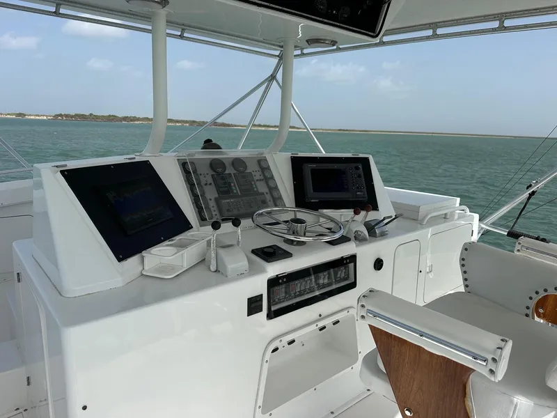 Slide: The Image of 1990 Bertram 50 Convertible yacht helm with navigation equipment and ocean view. - 4