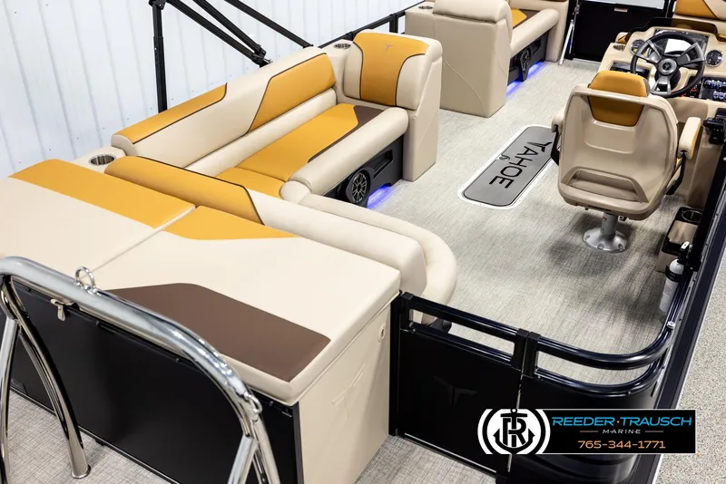 Slide: The Image of Luxurious 2025 Tahoe SP Cr boat interior with beige and brown seating, steering console, and branded flooring. - 12
