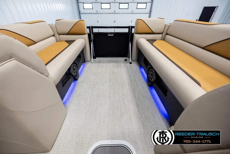 Slide: The Image of 2025 Tahoe SP Cr boat interior with beige and tan seating, blue LED lighting. - 18