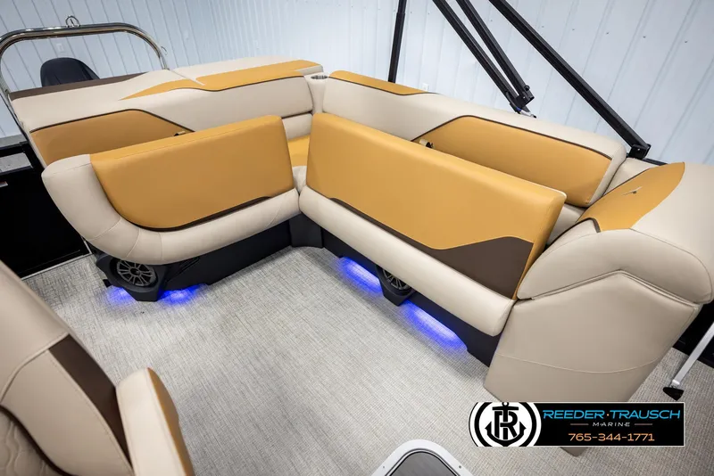 Slide: The Image of Luxurious 2025 Tahoe SP Cr boat interior with tan and brown seating, blue LED lighting. - 21