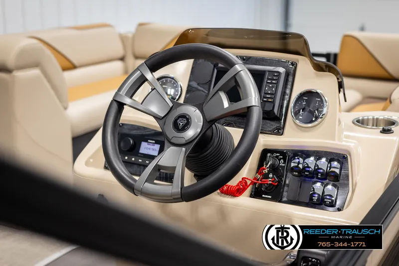 Slide: The Image of Steering wheel and dashboard of 2025 Tahoe SP Cr boat, featuring modern controls and gauges. - 24
