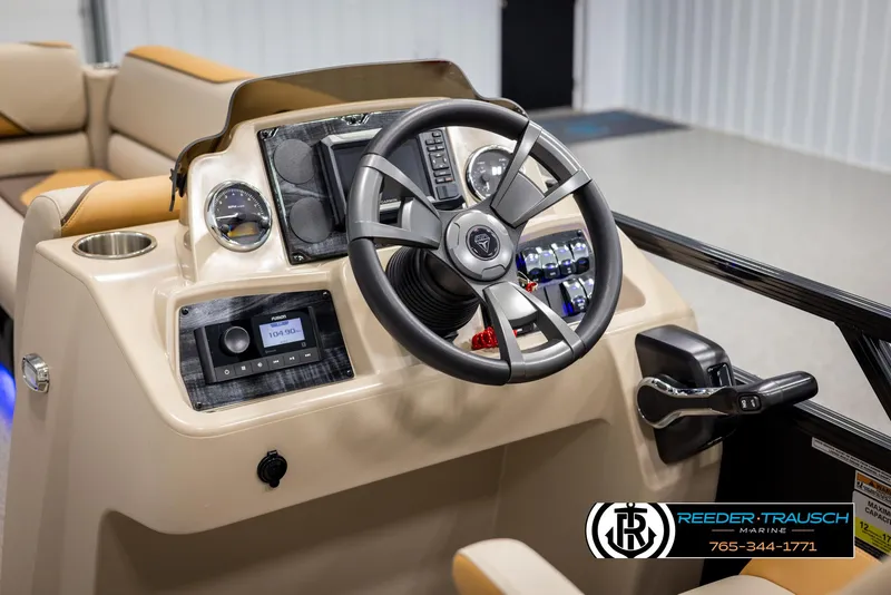Slide: The Image of 2025 Tahoe SP Cr boat dashboard with steering wheel and control panel. - 25