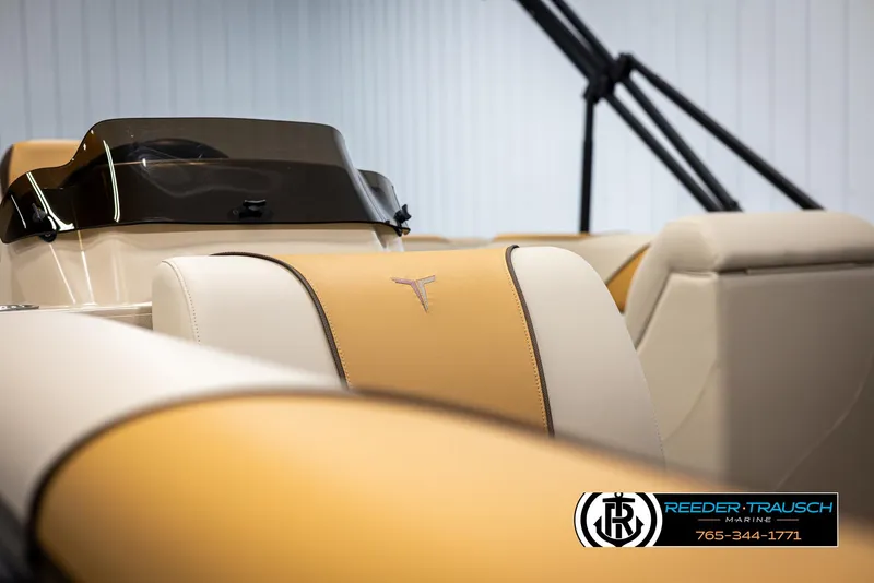Slide: The Image of 2025 Tahoe SP Cr boat interior with tan and cream seating, featuring Reeder-Trausch Marine logo. - 34