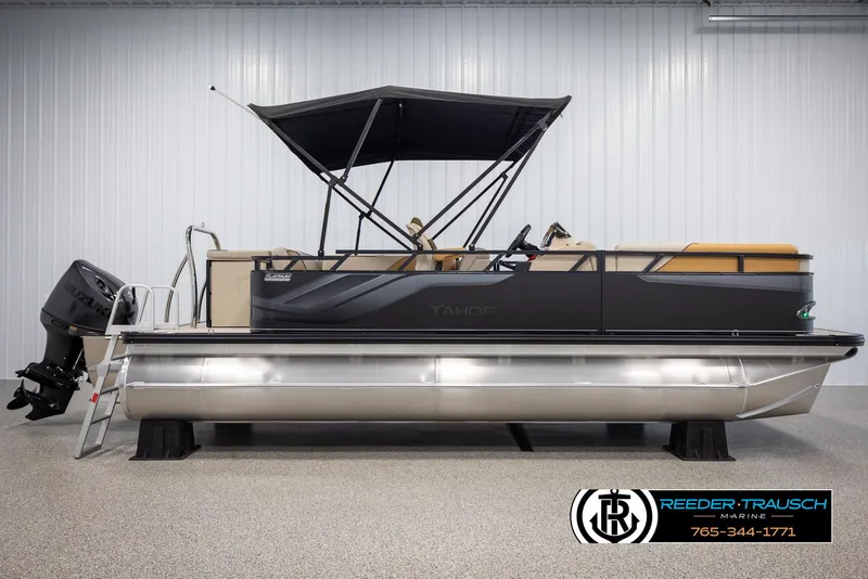 Slide: The Image of 2025 Tahoe SP Cr pontoon boat with canopy and Suzuki outboard motor in showroom. - 5