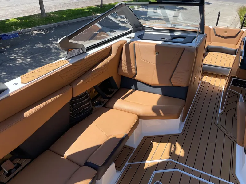 Slide: The Image of 2025 Nautique Super Air Nautique G25 interior with tan leather seating and sleek design. - 10