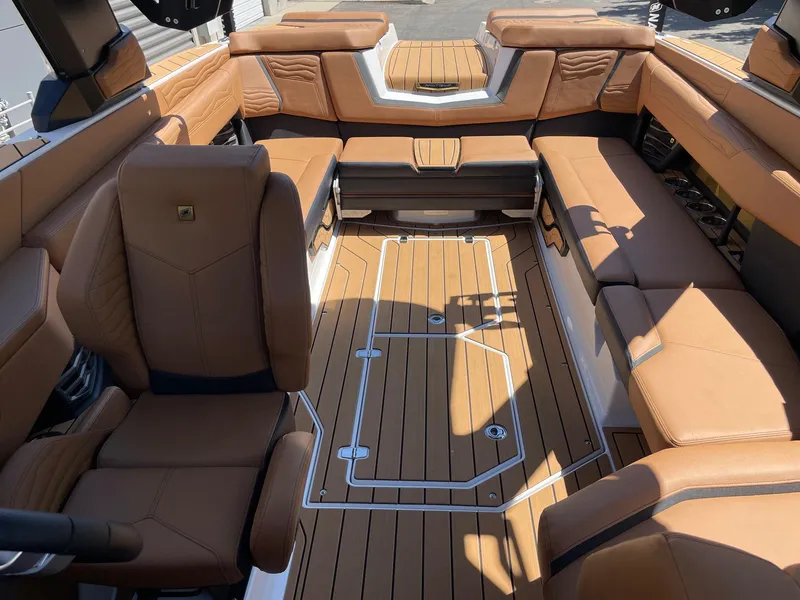 Slide: The Image of Luxurious interior of 2025 Nautique Super Air Nautique G25 with tan leather seating. - 12