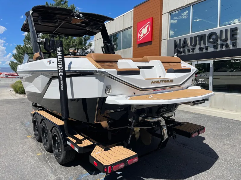 Slide: The Image of 2025 Nautique Super Air Nautique G25 boat on trailer outside dealership. - 3