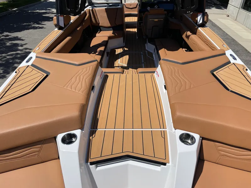 Slide: The Image of 2025 Nautique Super Air Nautique G25 interior with tan upholstery and sleek design. - 4