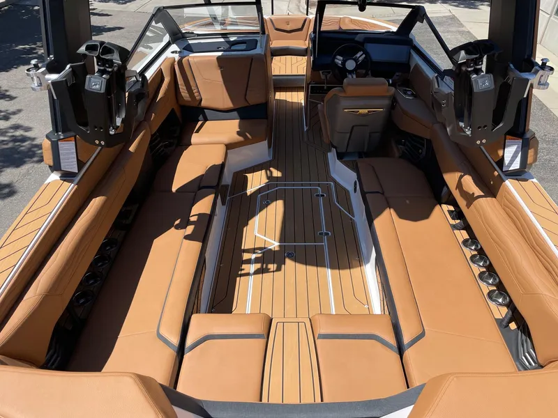 Slide: The Image of 2025 Nautique Super Air Nautique G25 interior with luxurious tan seating and sleek design. - 5