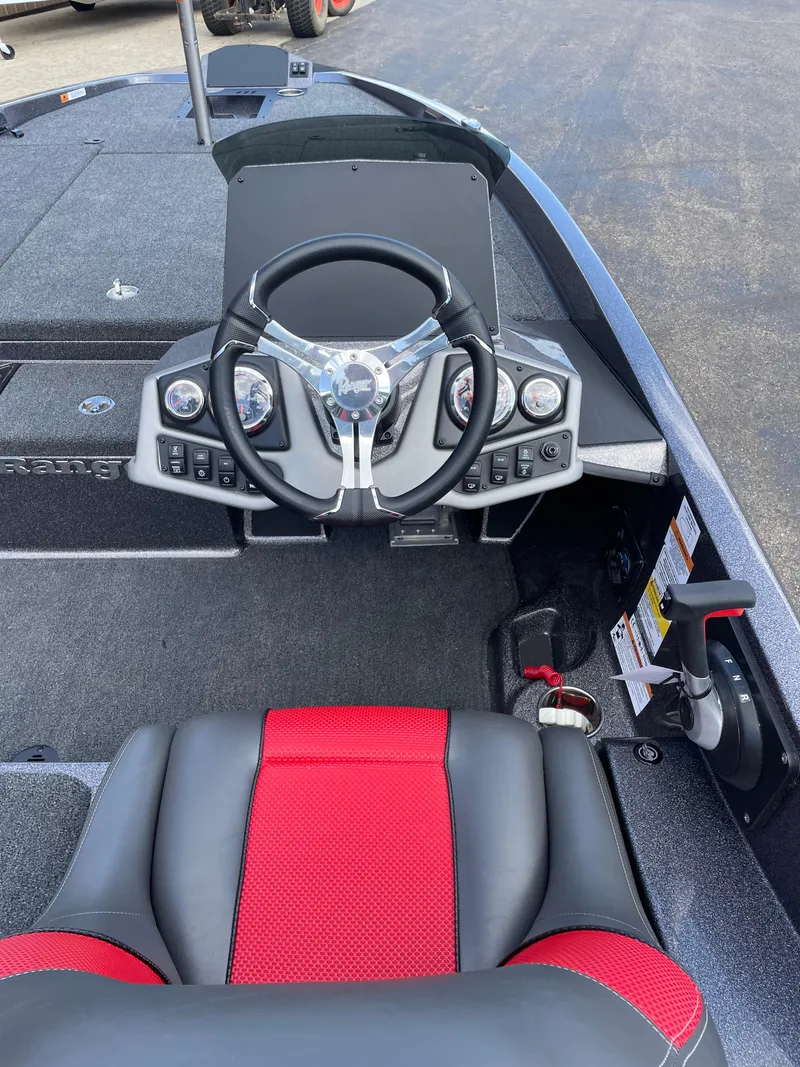 Slide: The Image of 2025 Ranger Z185 boat cockpit with steering wheel and red-accented seat. - 6