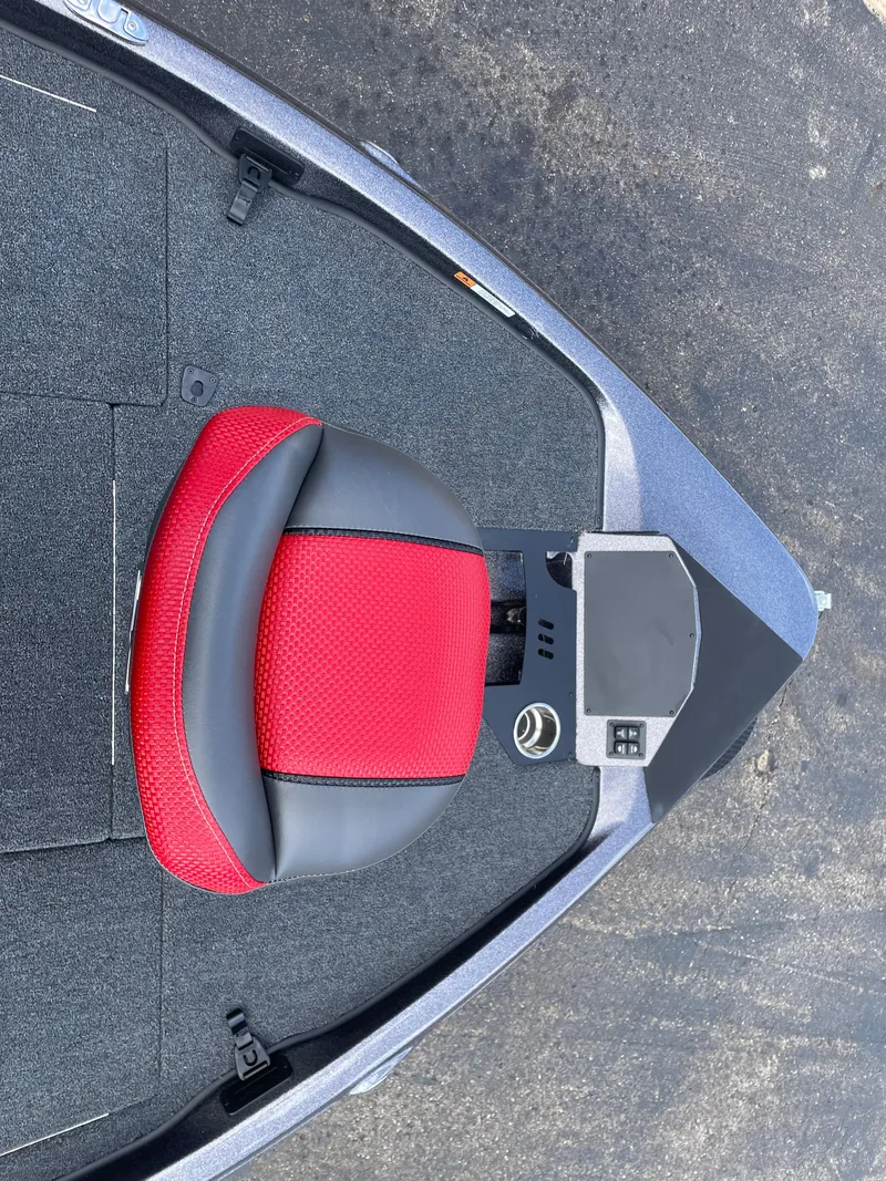 Slide: The Image of 2025 Ranger Z185 boat with red and black seat, control panel, and carpeted deck. - 8