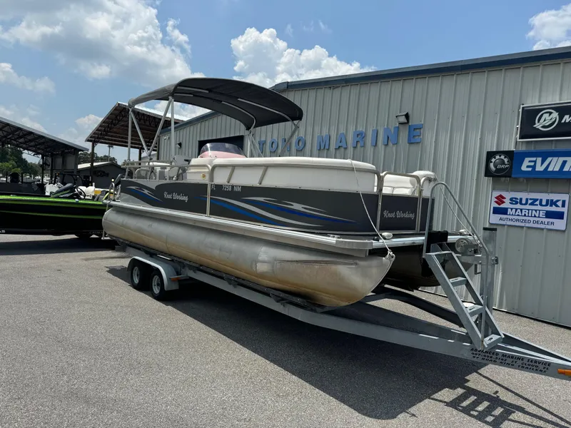 Slide: The Image of 2007 SunChaser 8522 Cruise RE pontoon boat on trailer outside marine shop. - 1