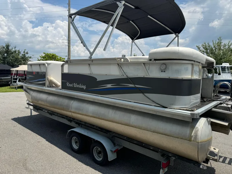 Slide: The Image of 2007 SunChaser 8522 Cruise RE pontoon boat on trailer, under a cloudy sky. - 2