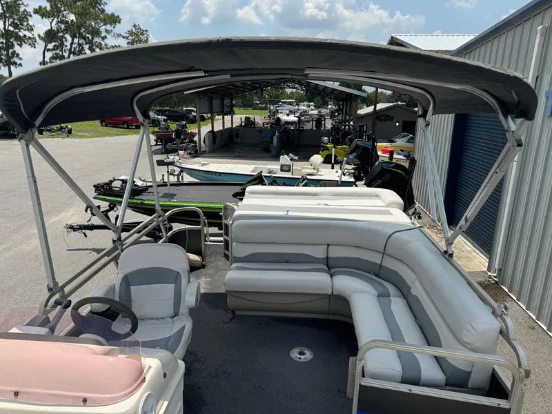 Slide: The Image of 2007 SunChaser 8522 Cruise RE pontoon boat with canopy and seating, parked outdoors. - 4