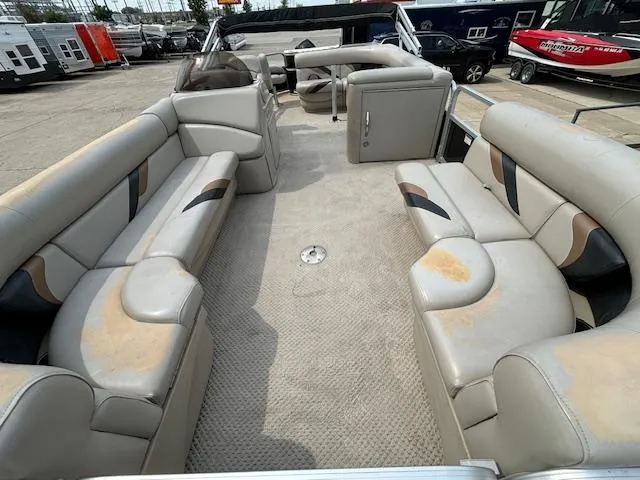 Slide: The Image of 2012 SunChaser 8522 C-N-F pontoon boat interior with beige seating and carpet. - 13