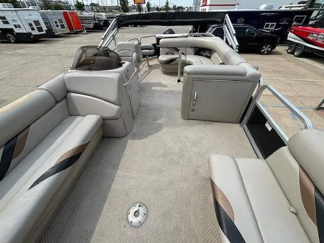 Slide: The Image of 2012 SunChaser 8522 C-N-F pontoon boat interior with beige seating and helm. - 14