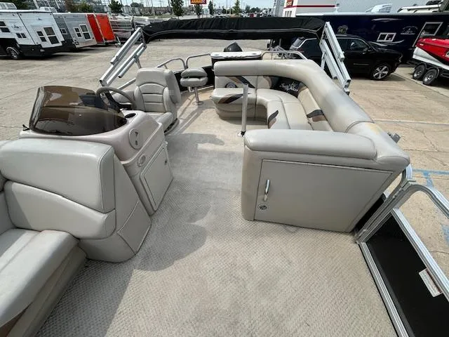 Slide: The Image of 2012 SunChaser 8522 C-N-F pontoon boat interior with beige seating and helm. - 15
