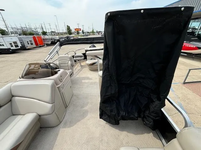 Slide: The Image of 2012 SunChaser 8522 C-N-F pontoon boat interior with seating and black privacy curtain. - 16