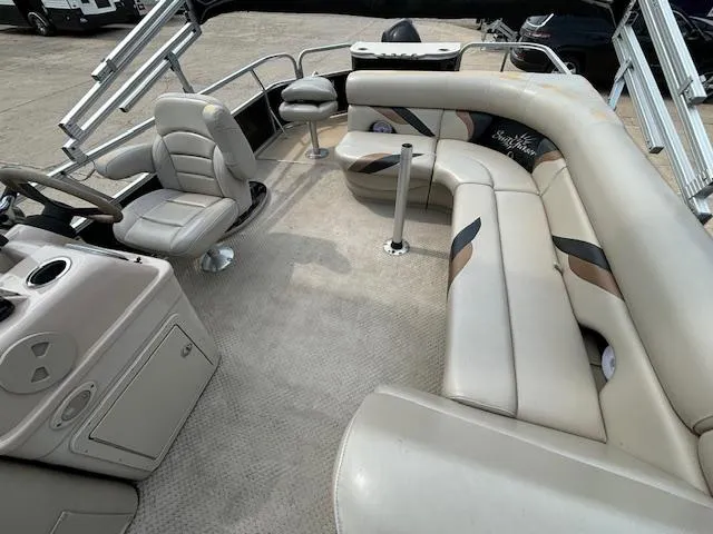 Slide: The Image of 2012 SunChaser 8522 C-N-F pontoon boat interior with beige seating and steering console. - 18