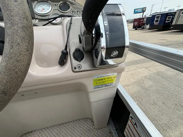 Slide: The Image of 2012 SunChaser 8522 C-N-F boat control panel with throttle and gauges. - 25