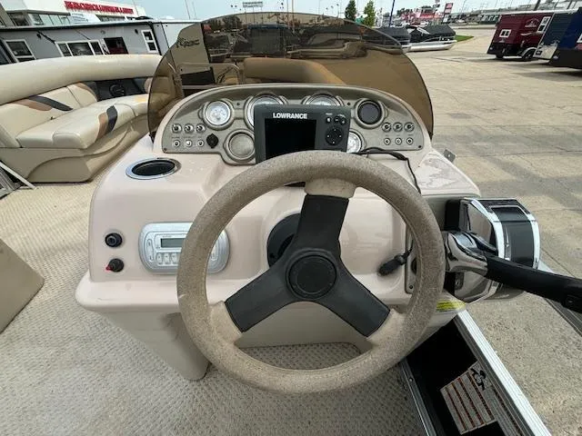 Slide: The Image of 2012 SunChaser 8522 C-N-F boat dashboard with steering wheel and navigation system. - 26