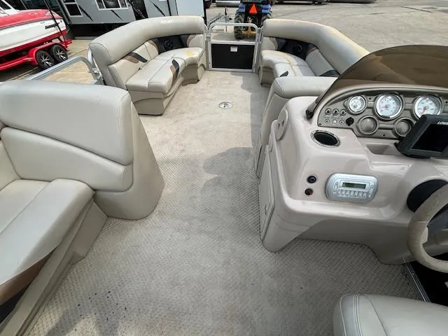 Slide: The Image of Interior of 2012 SunChaser 8522 C-N-F pontoon boat with beige seating and dashboard. - 29