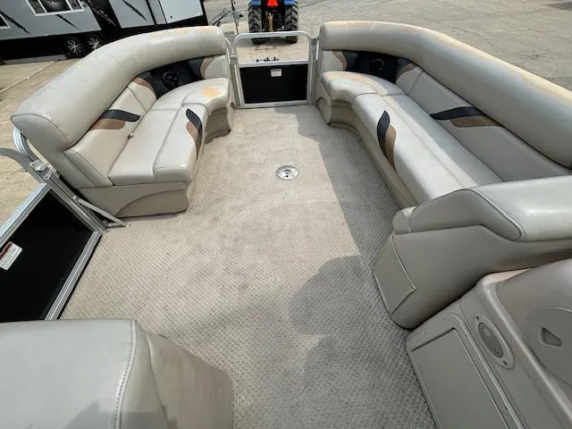 Slide: The Image of 2012 SunChaser 8522 C-N-F pontoon boat interior with beige seating and carpet. - 30