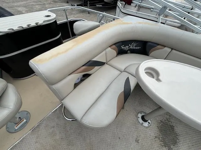 Slide: The Image of 2012 SunChaser 8522 C-N-F pontoon boat interior with beige seating and table. - 32