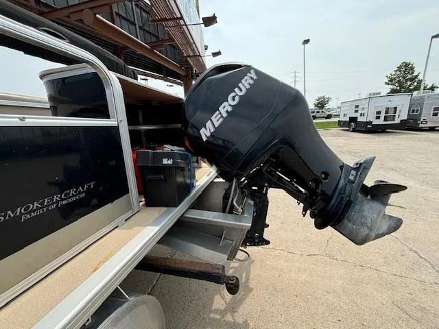 Slide: The Image of Mercury outboard motor on 2012 SunChaser 8522 C-N-F pontoon boat in parking lot. - 8