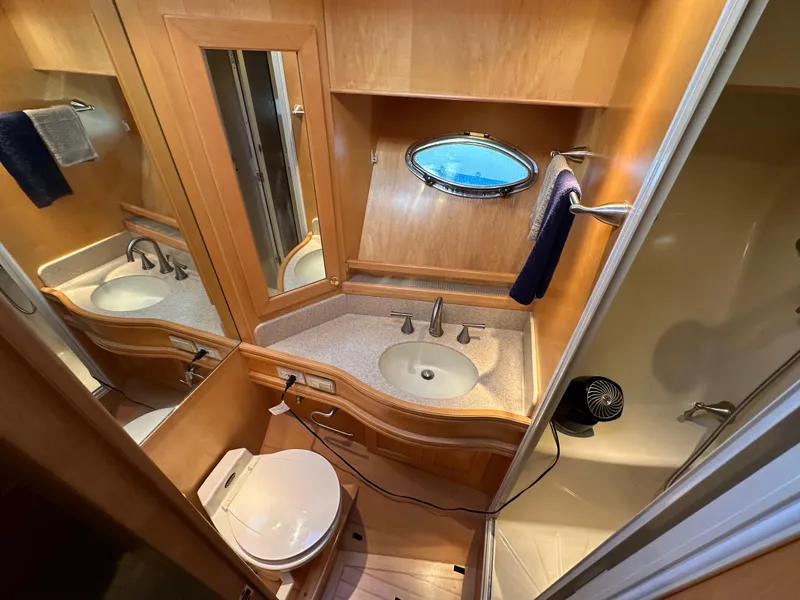 Slide: The Image of Bathroom interior of 1999 McKinna 47 Sedan yacht with sink, toilet, and shower. - 15