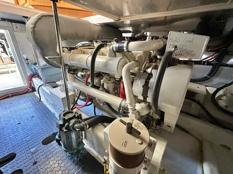Slide: The Image of Engine room of 1999 McKinna 47 Sedan yacht, showcasing mechanical components. - 18