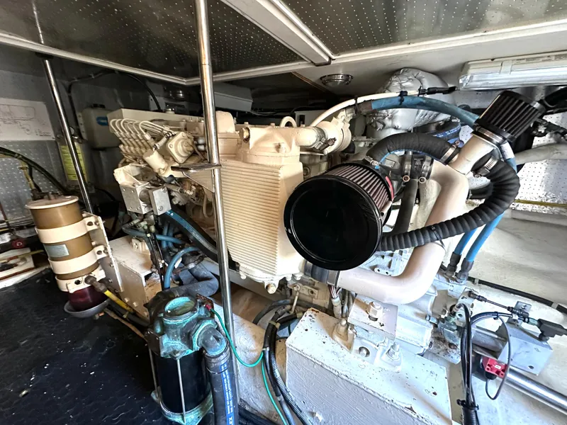 Slide: The Image of Engine room of a 1999 McKinna 47 Sedan yacht, showcasing mechanical components. - 19