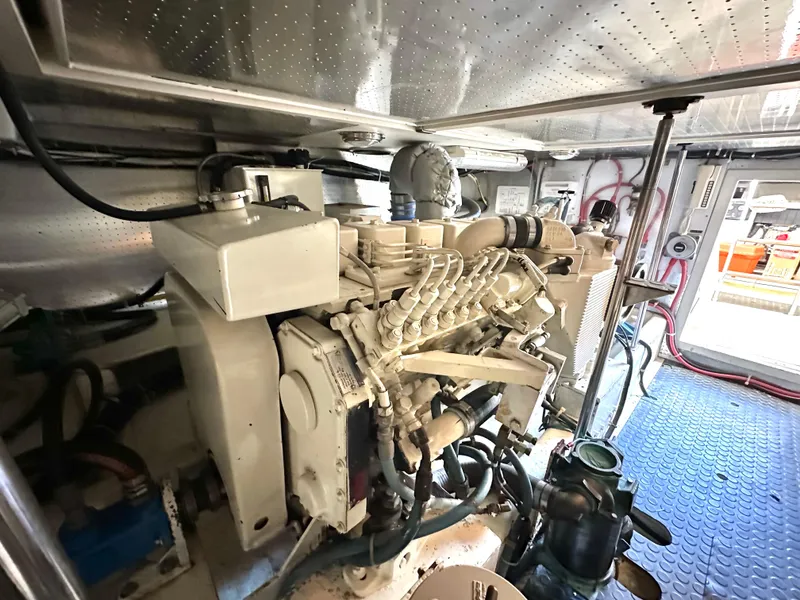 Slide: The Image of Engine room of 1999 McKinna 47 Sedan yacht, showcasing mechanical components. - 20