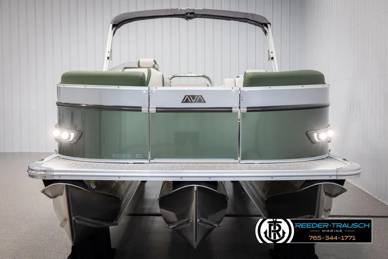 Slide: The Image of 2025 Avalon Catalina EL pontoon boat, rear view, green and silver design, in showroom. - 8