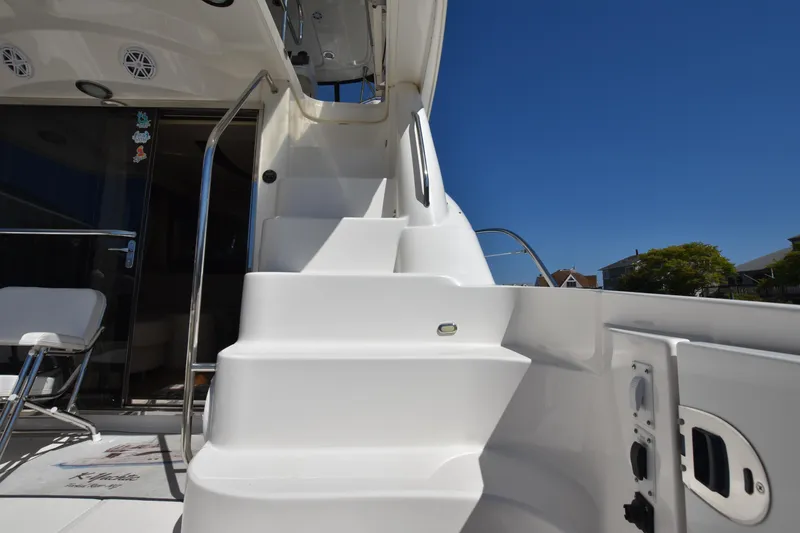 Slide: The Image of Staircase on 2006 Sea Ray 58 Sedan Bridge yacht under clear blue sky. - 11