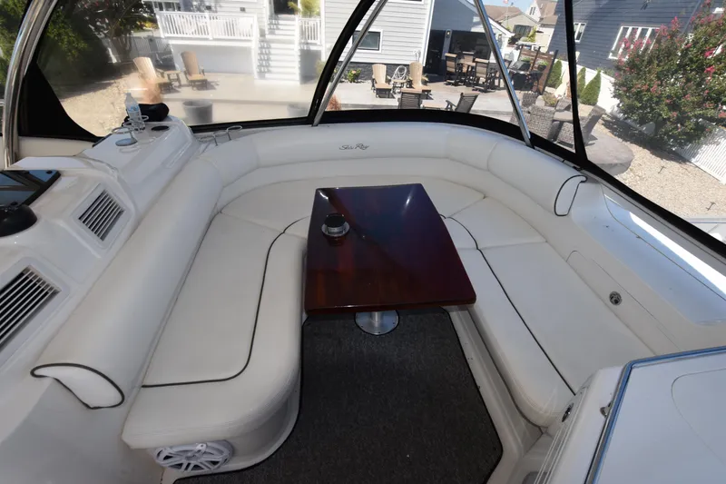 Slide: The Image of Luxurious 2006 Sea Ray 58 Sedan Bridge interior with white seating and wooden table. - 20