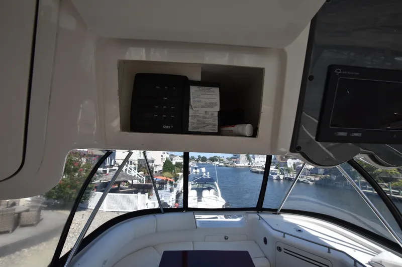 Slide: The Image of Interior view of 2006 Sea Ray 58 Sedan Bridge yacht with marina in background. - 22