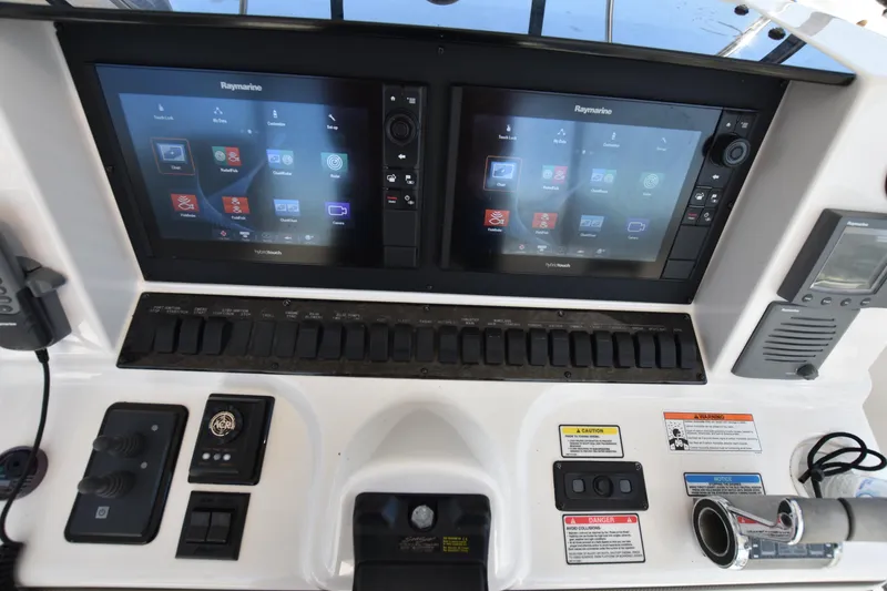 Slide: The Image of 2006 Sea Ray 58 Sedan Bridge helm with dual Raymarine displays and control panel. - 23