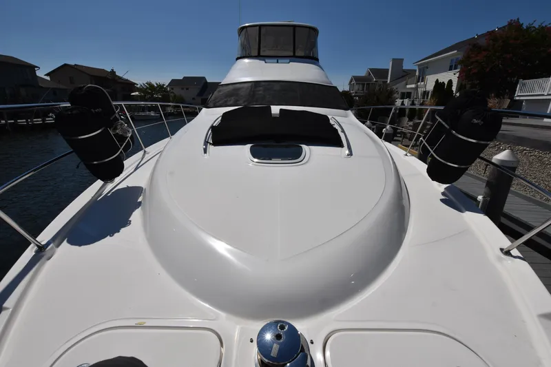 Slide: The Image of 2006 Sea Ray 58 Sedan Bridge yacht docked, showcasing sleek design and spacious deck. - 28