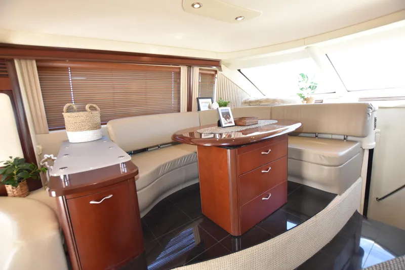 Slide: The Image of Luxurious interior of 2006 Sea Ray 58 Sedan Bridge yacht with elegant seating and wooden cabinetry. - 38