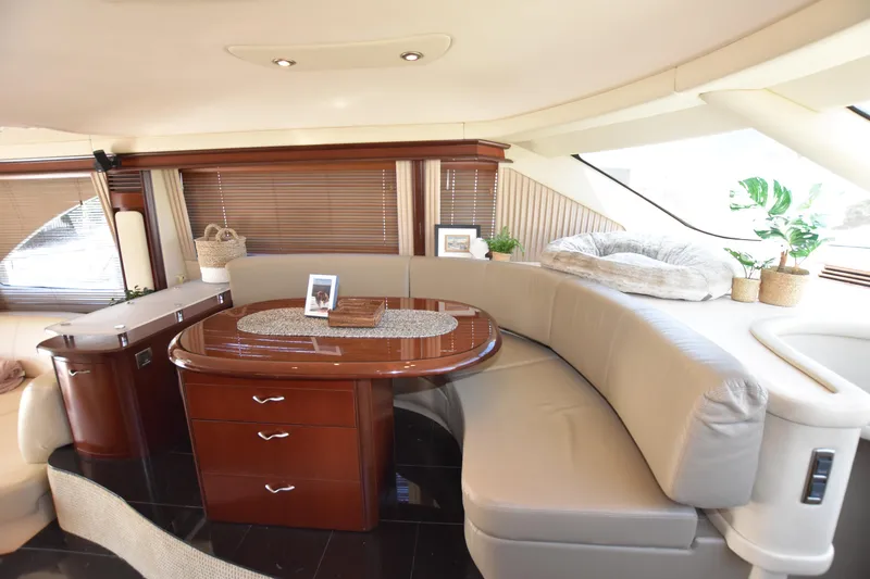 Slide: The Image of Luxurious interior of 2006 Sea Ray 58 Sedan Bridge yacht with elegant seating and table. - 39