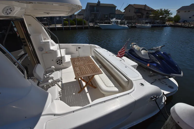 Slide: The Image of 2006 Sea Ray 58 Sedan Bridge yacht with deck seating and jet ski, docked in marina. - 5