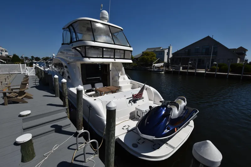 Slide: The Image of 2006 Sea Ray 58 Sedan Bridge yacht docked with jet ski on platform. - 6