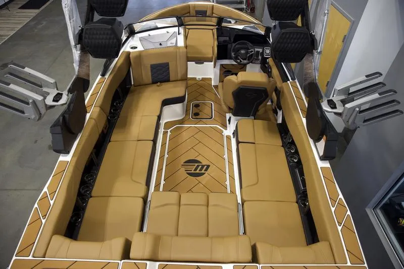 Slide: The Image of 2025 Malibu 23 LSV boat interior with tan seating and modern design. - 10