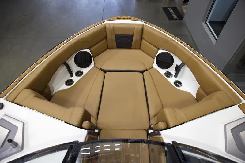 Slide: The Image of Luxurious interior of 2025 Malibu 23 LSV boat with tan seating and speakers. - 16