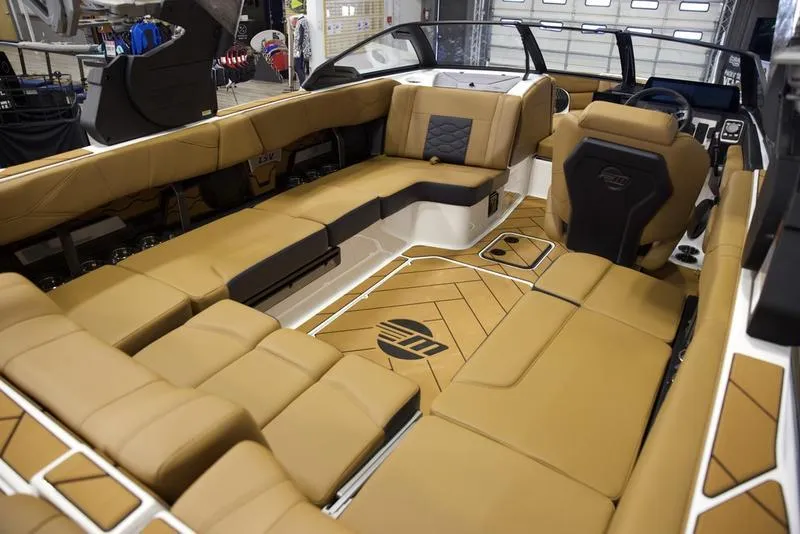 Slide: The Image of Luxurious interior of 2025 Malibu 23 LSV boat with tan seating and modern design. - 17