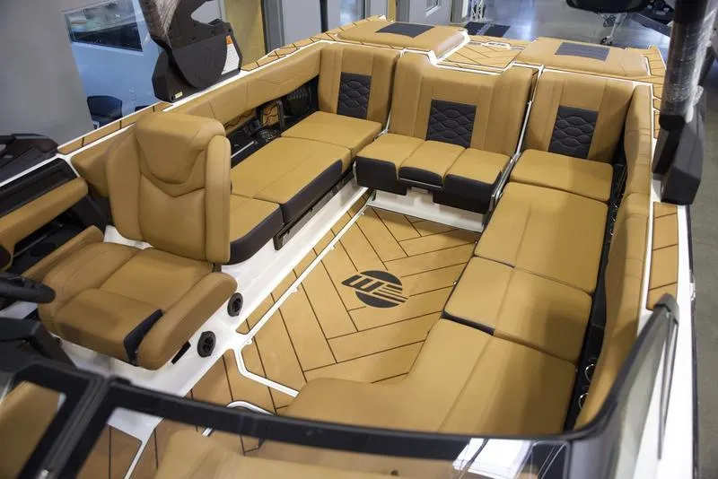 Slide: The Image of Luxurious interior of 2025 Malibu 23 LSV boat with tan seating and modern design. - 20